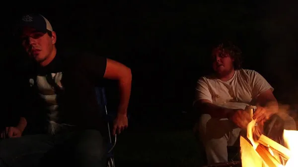Cinematic night scene beside a fire
